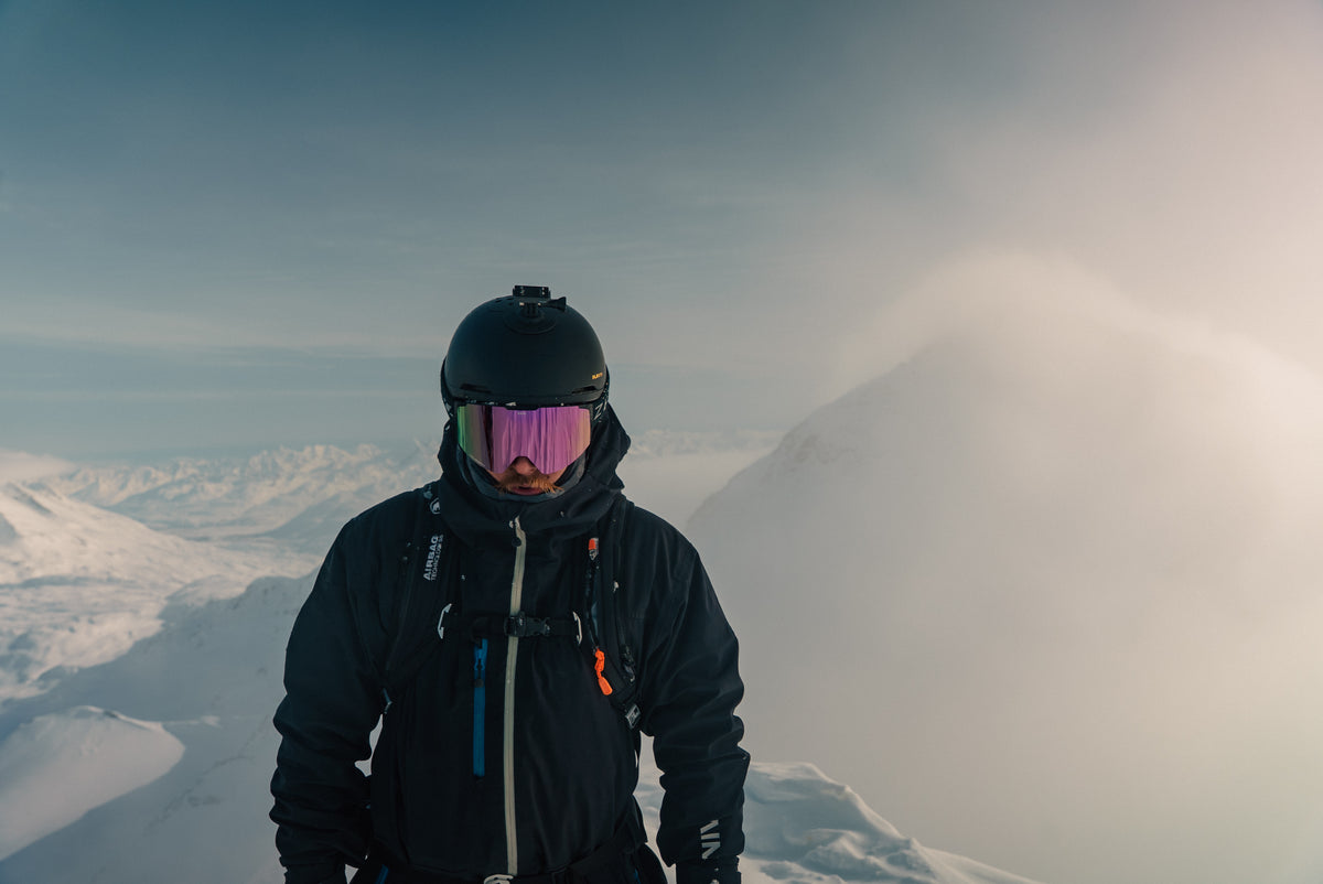 A skier traversing a ridgeline in flat light