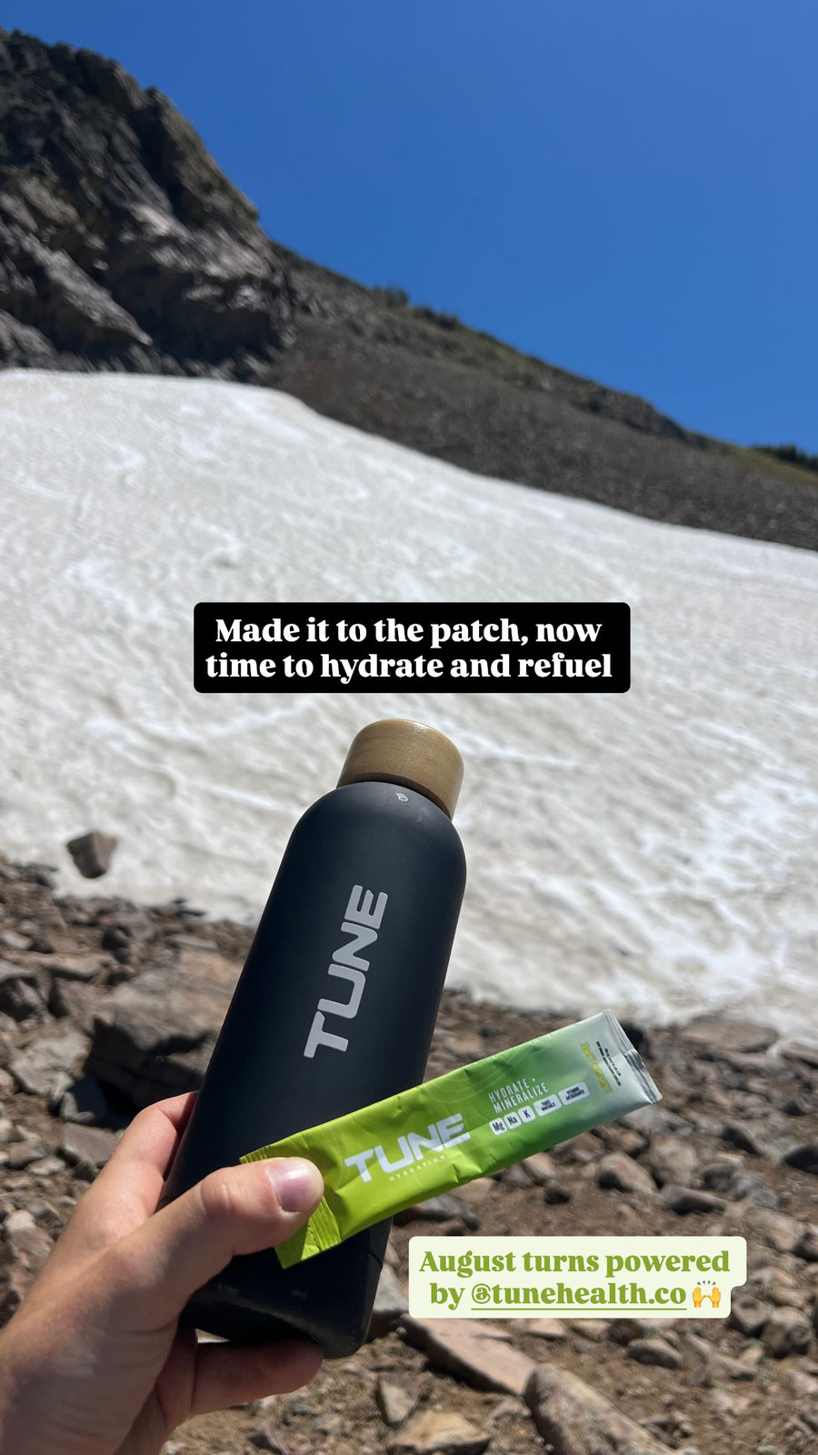 A Tune bottle and Lemon Lime stick pack on an August snow patch above Lake Tahoe
