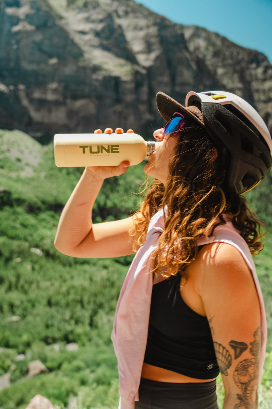 Rider drinking from a Tune bottle on a morning ride